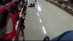 Voyeur and foot fetish in a public place. Beautiful legs in stockings and a juicy ass under a short dress in a shoe store.